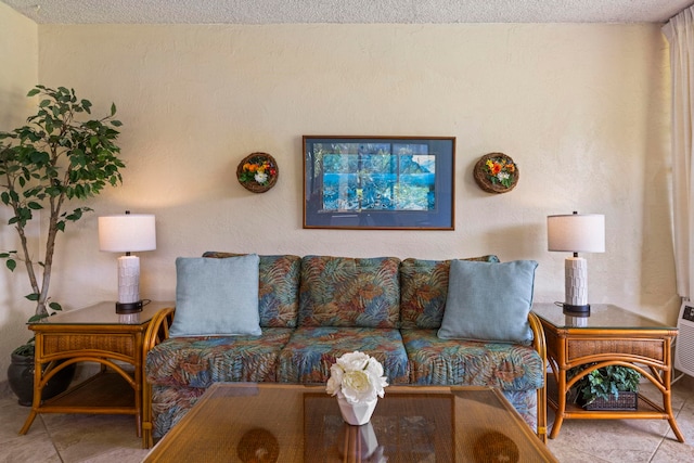 tiled living room featuring a textured ceiling