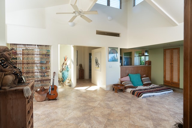 living area featuring a high ceiling and ceiling fan