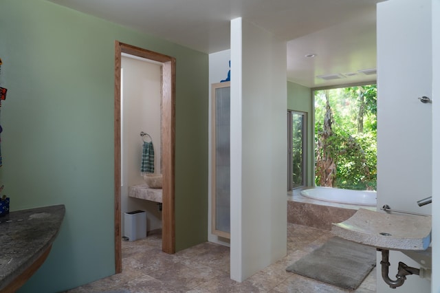 bathroom featuring shower with separate bathtub