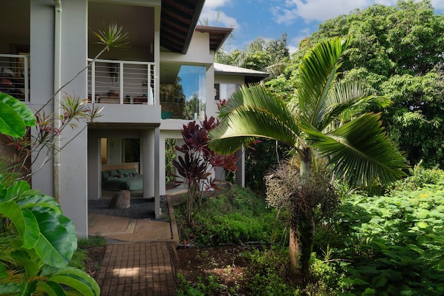 view of side of home with a balcony and a patio area