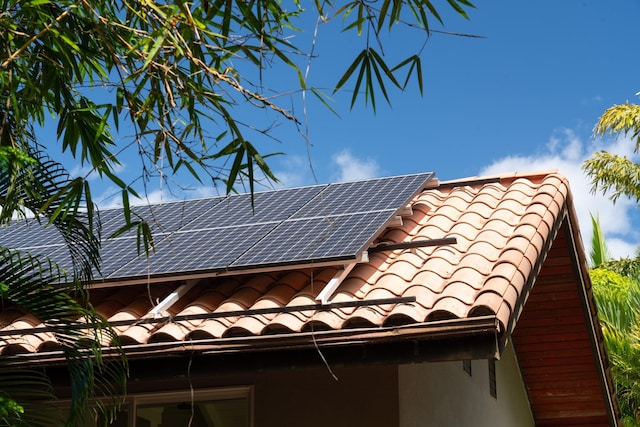 view of side of property featuring solar panels