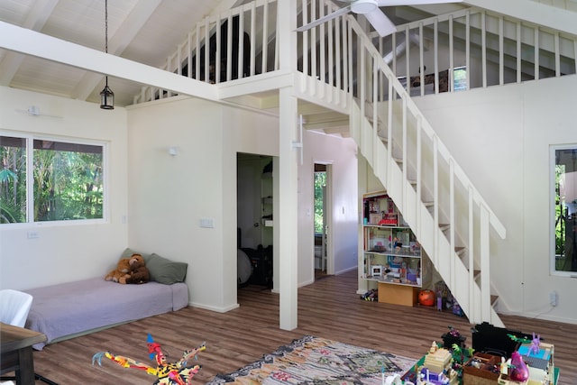 interior space featuring beamed ceiling, hardwood / wood-style floors, high vaulted ceiling, and wooden ceiling