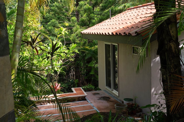 view of side of property with a patio area