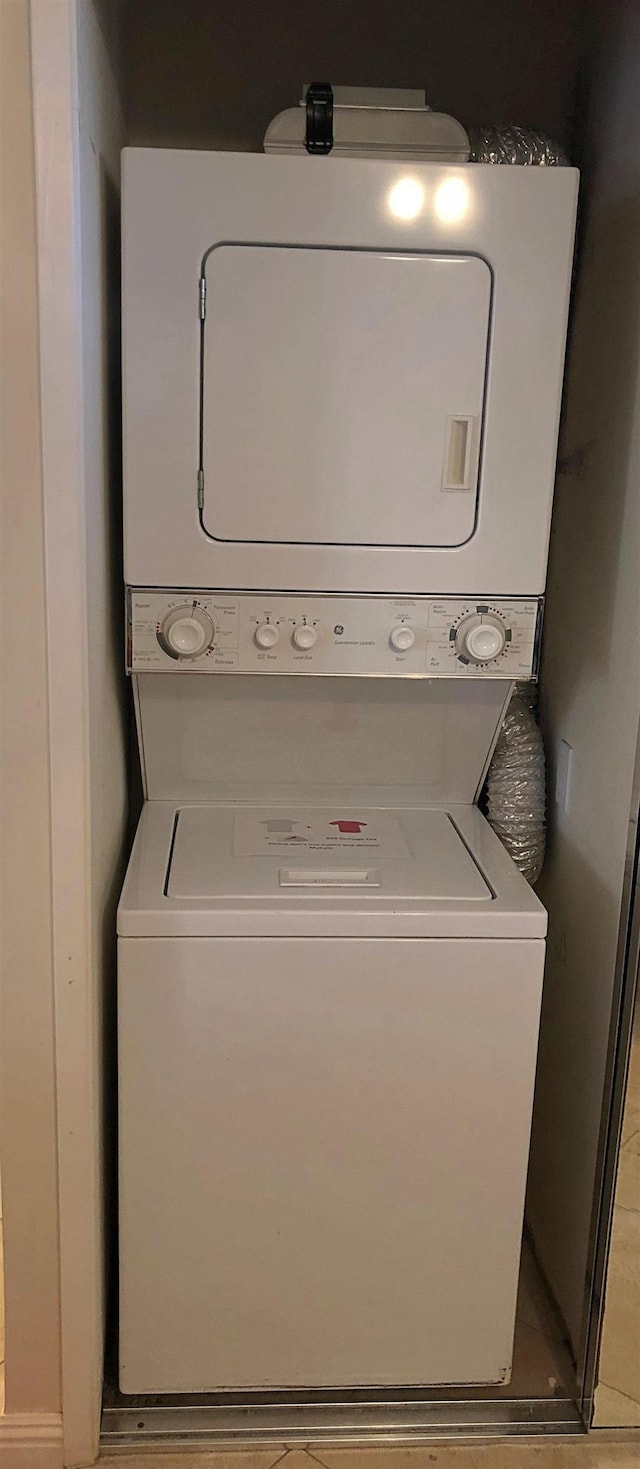 clothes washing area with stacked washer / drying machine