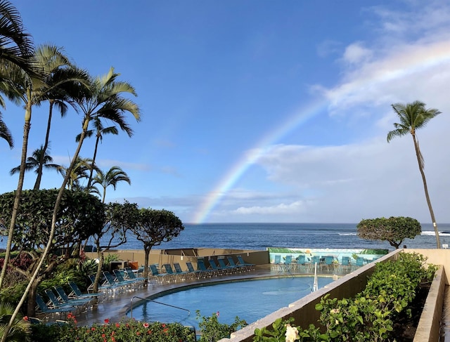 view of pool with a water view