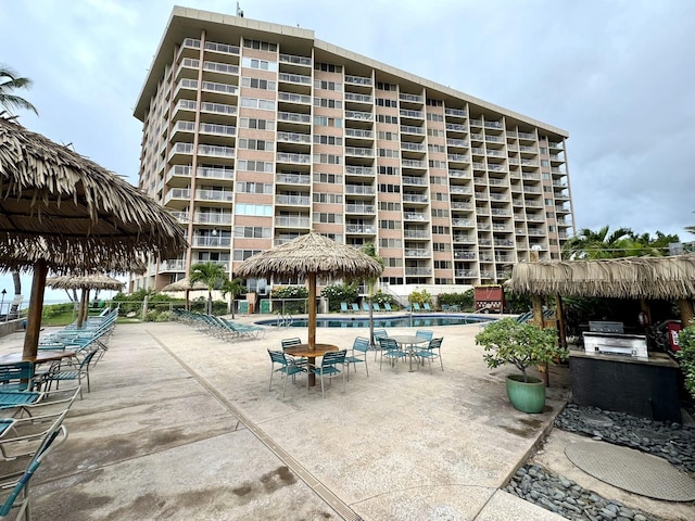 view of pool with a patio area and exterior kitchen