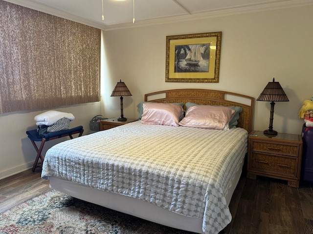 bedroom with ornamental molding and dark hardwood / wood-style floors