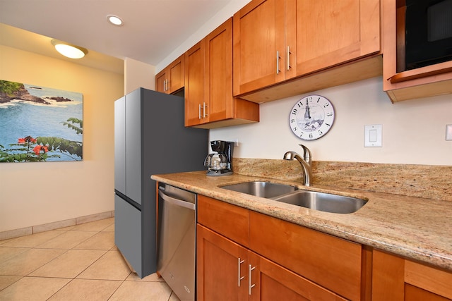 kitchen featuring stainless steel dishwasher, light stone counters, light tile floors, and sink