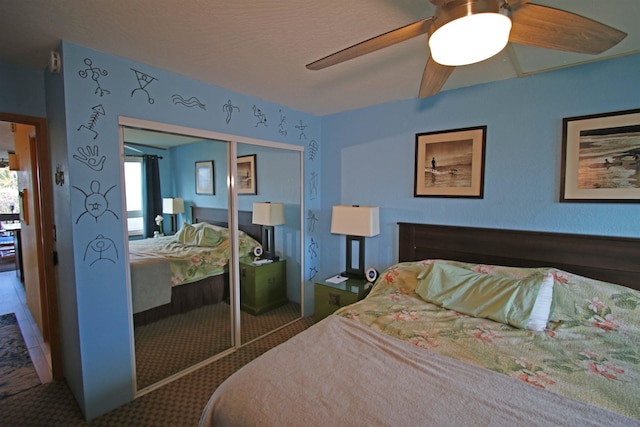 bedroom with ceiling fan and a closet