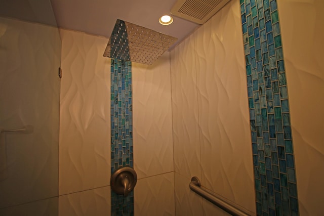 bathroom with a tile shower