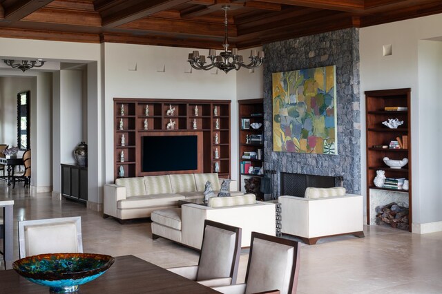 living room featuring beamed ceiling, a fireplace, an inviting chandelier, wooden ceiling, and coffered ceiling