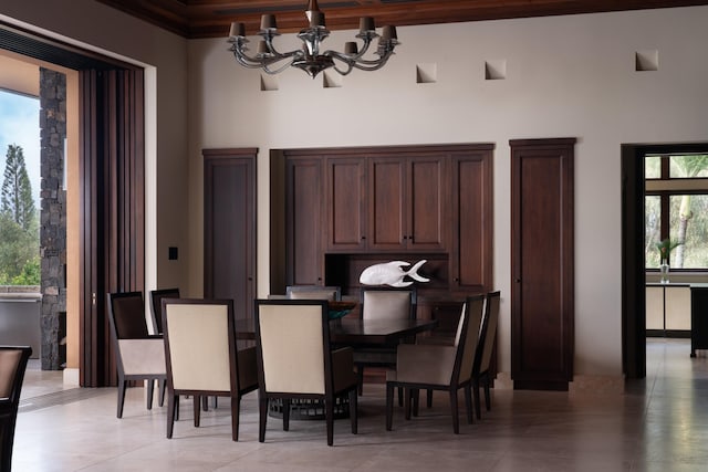 dining space featuring a chandelier and a high ceiling