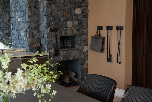 living room featuring a stone fireplace