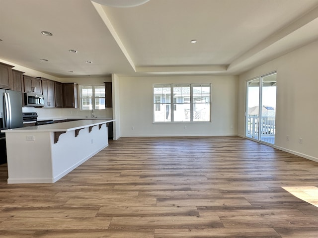 kitchen with a breakfast bar, plenty of natural light, and appliances with stainless steel finishes