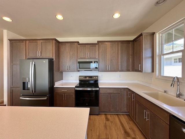 kitchen featuring light hardwood / wood-style floors, sink, and appliances with stainless steel finishes