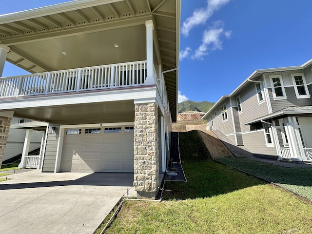 view of side of property featuring a garage and a yard