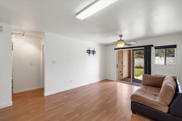 80 Waiaka Ln Unit 37-103, Wailuku, HI 96793 - living room with light wood-type flooring, track lighting, and a ceiling fan