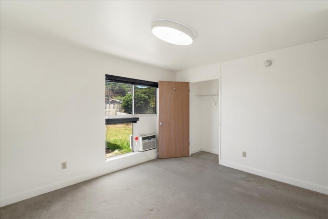 80 Waiaka Ln Unit 37-103, Wailuku, HI 96793 - unfurnished bedroom with a wall mounted air conditioner, carpet floors, and a closet