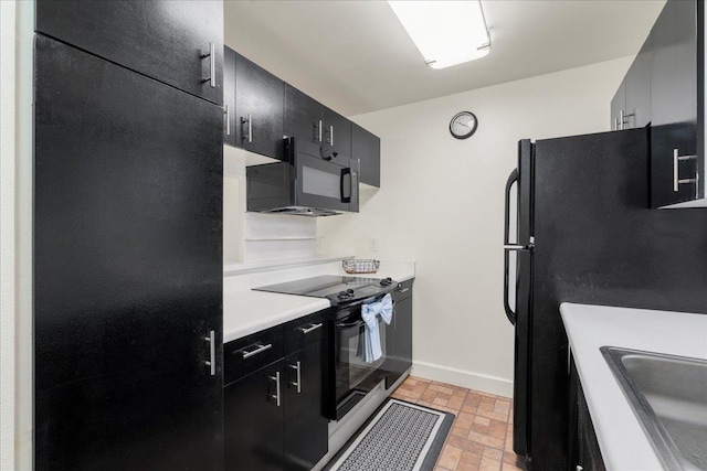 80 Waiaka Ln Unit 37-103, Wailuku, HI 96793 - kitchen featuring black appliances, dark cabinets, brick patterned floors, and light countertops