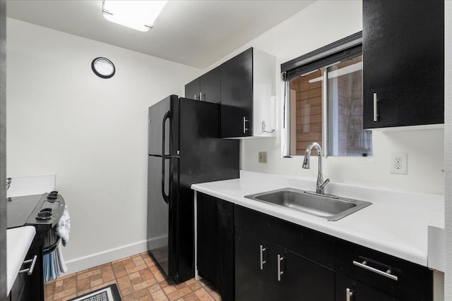 80 Waiaka Ln Unit 37-103, Wailuku, HI 96793 - kitchen with dark cabinetry, light countertops, brick patterned flooring, and freestanding refrigerator