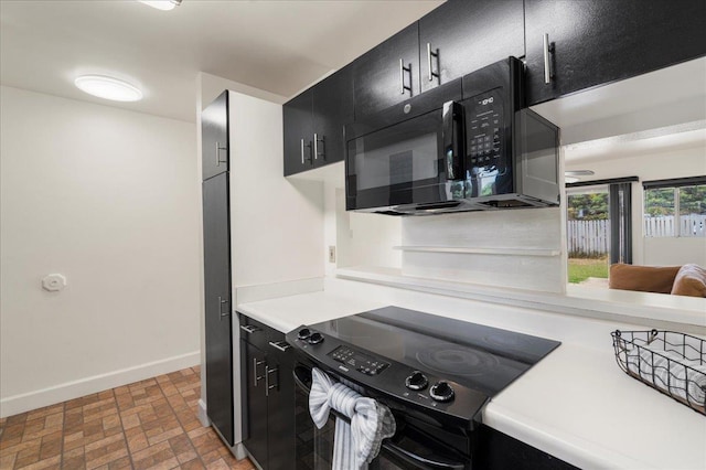 80 Waiaka Ln Unit 37-103, Wailuku, HI 96793 - kitchen with black appliances, dark cabinets, brick patterned floors, and light countertops