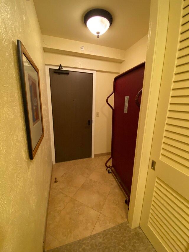 hallway with tile flooring