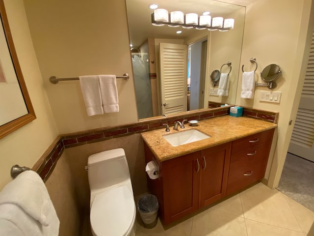 bathroom featuring tile floors, toilet, and vanity