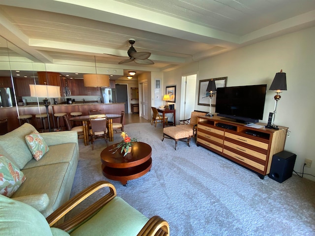 living room featuring carpet, ceiling fan, and beam ceiling