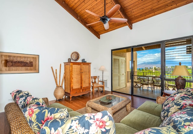 living room featuring beamed ceiling, wooden ceiling, wood finished floors, and a ceiling fan