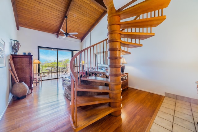staircase with wood finished floors, wood ceiling, ceiling fan, baseboards, and beam ceiling