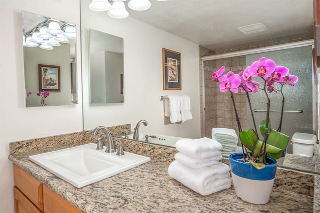 full bathroom with vanity and tiled shower