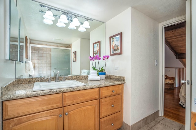 full bathroom featuring a shower stall, tile patterned floors, visible vents, vanity, and ensuite bathroom
