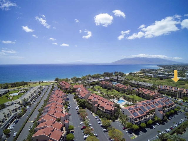 birds eye view of property with a water and mountain view