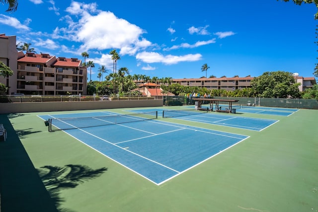 view of tennis court featuring fence