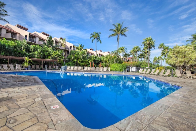 community pool with a residential view and a patio