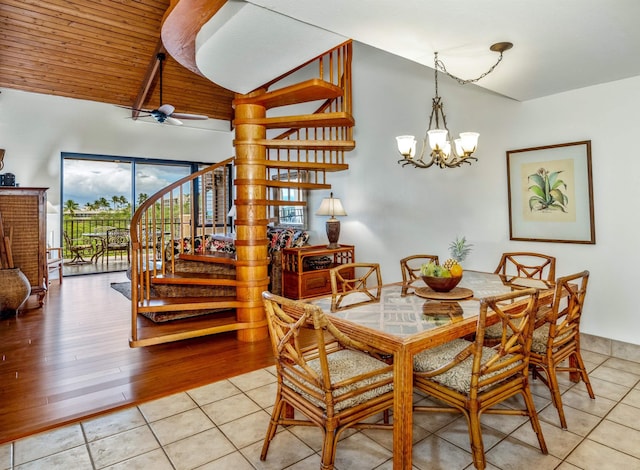 dining area featuring light tile patterned flooring, plenty of natural light, lofted ceiling, and stairway