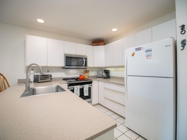 2777 S Kihei Rd Unit K-101, Kihei, HI 96753 - kitchen featuring appliances with stainless steel finishes, light countertops, recessed lighting, white cabinets, and light tile patterned flooring