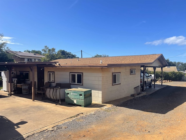 rear view of house featuring a carport