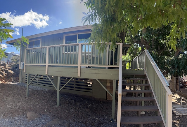 rear view of house featuring a wooden deck