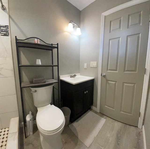 bathroom featuring hardwood / wood-style floors, vanity, and toilet