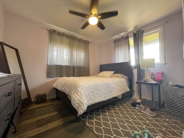 bedroom with ceiling fan and dark wood-type flooring