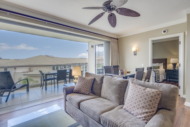 living room with crown molding, hardwood / wood-style floors, and ceiling fan