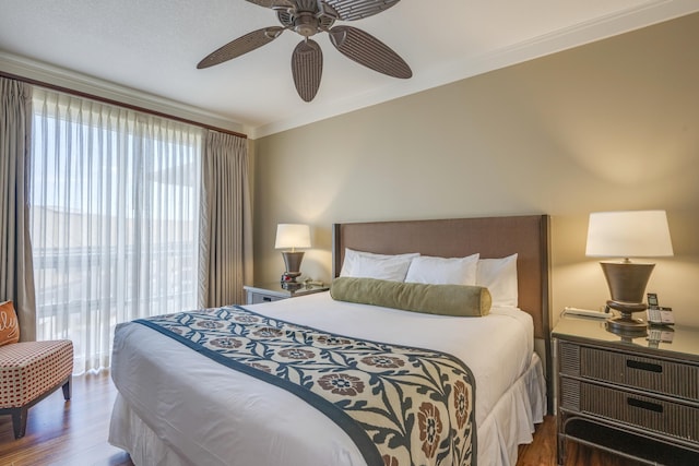 bedroom with crown molding, dark hardwood / wood-style floors, and ceiling fan