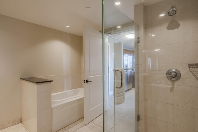 bathroom with tile patterned floors and independent shower and bath