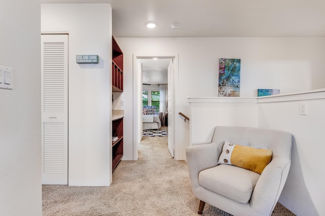 living area with light colored carpet