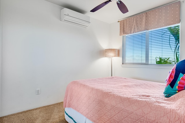 carpeted bedroom with a wall unit AC and ceiling fan