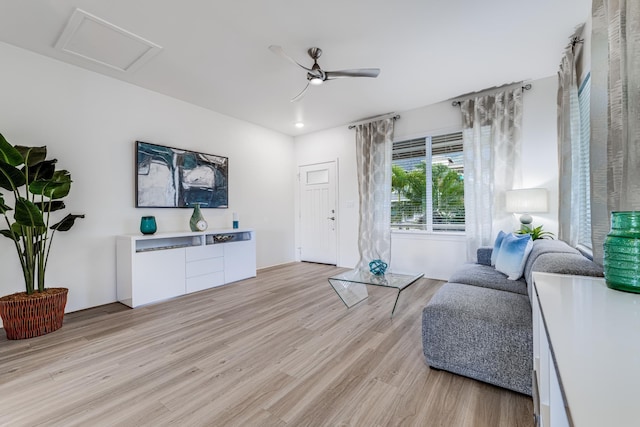 living room featuring ceiling fan and light hardwood / wood-style floors