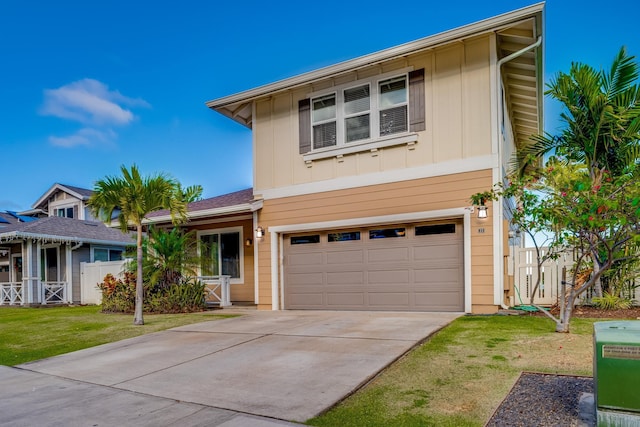 view of front of house featuring a garage and a front lawn