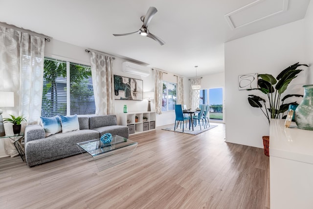 living room featuring ceiling fan, light hardwood / wood-style floors, and a wall mounted AC