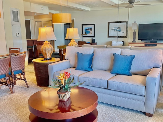 carpeted living room with beam ceiling and ceiling fan